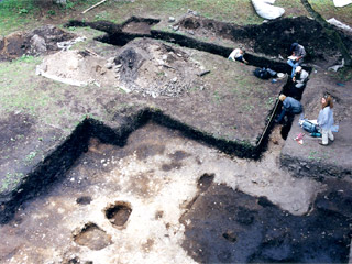 An aerial view of a group of archaeologists working in an archaeological area.