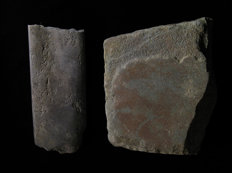 Two pieces of grey stone shaped into flat square pieces