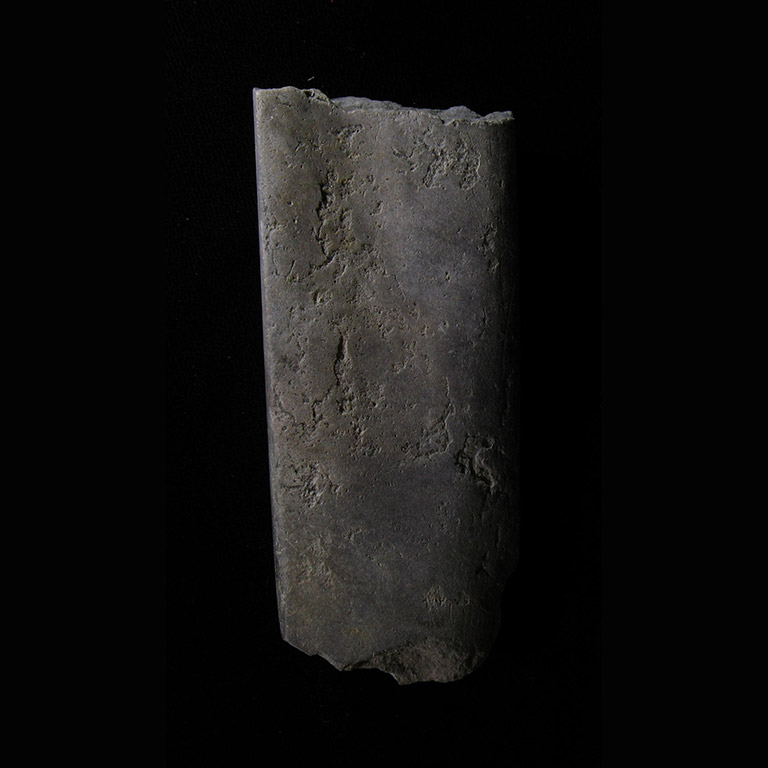 One piece of stone shaped into a flat square piece with a slight groove down the centre.