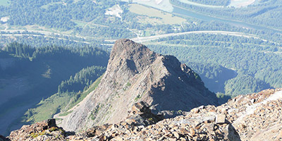 A rocky mountain peak set against the blue sky.